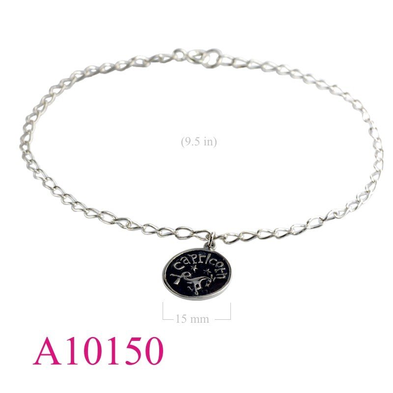 Anklet, chain with hanging round Capricorn charm.