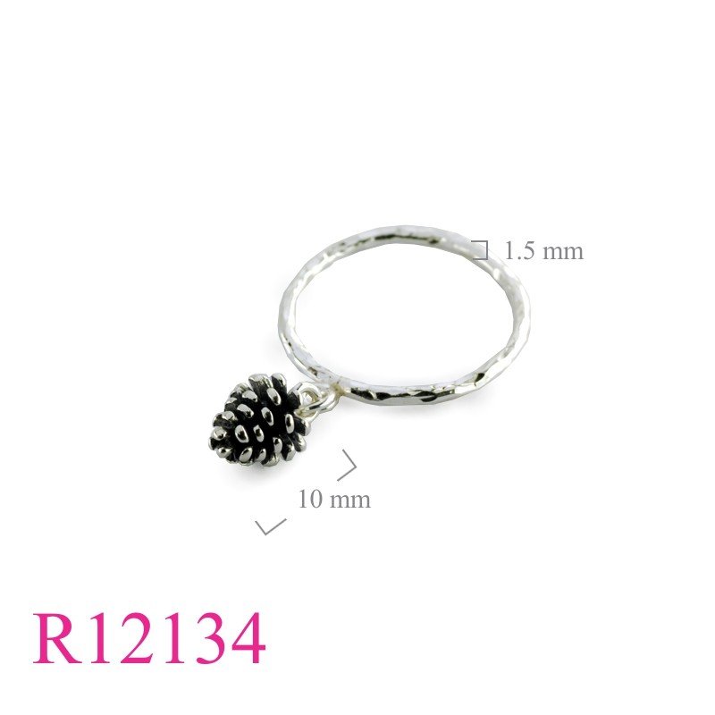 Ring, hammered wire and hanging evergreen nut.